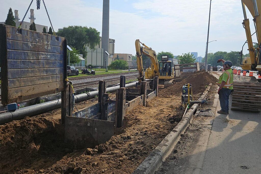 trench excavation with shoring and excavator